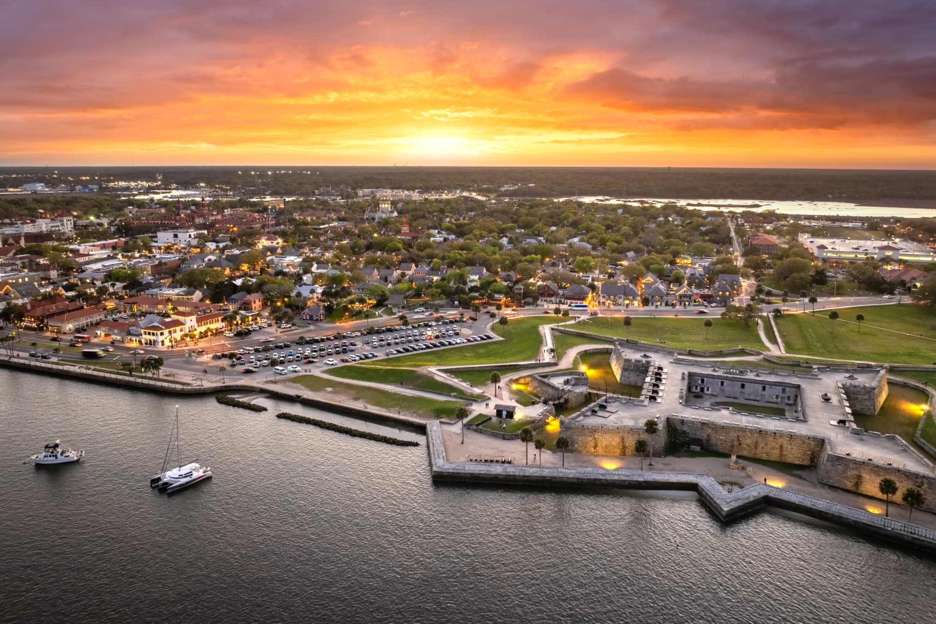 Aerial view of the Castillo de San Marcos at sunset with the old city beyond